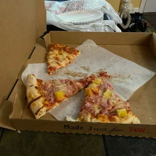 a half eaten pizza in a box