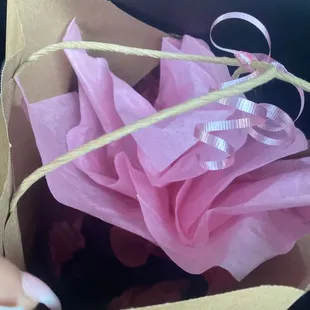 Two bottles of wine, a wine glass, and a T-shirt wrapped with love from the wonderful women at The Wine Cellar!