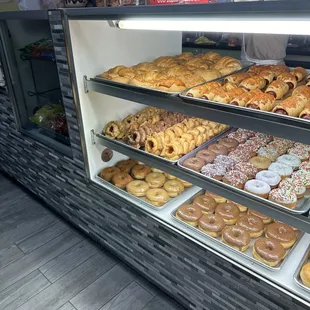 a variety of doughnuts in a display case