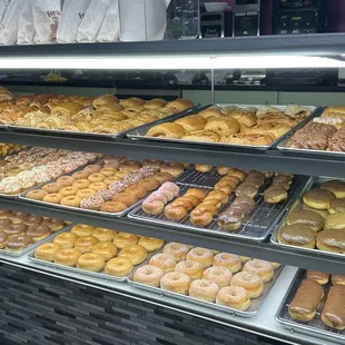 a variety of doughnuts in a display case