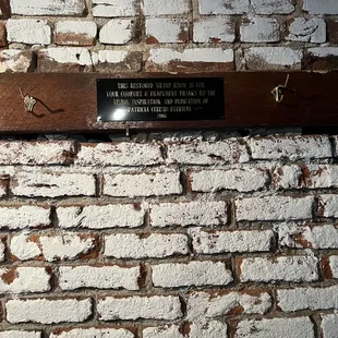 plaque on brick wall