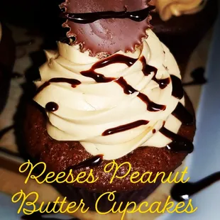 a chocolate cupcake with cream frosting and chocolate drizzle