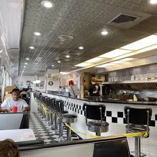 a boy sitting at a table in a diner