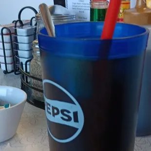 a blue cup with a red straw