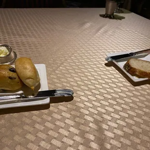 a plate of bread and butter on a table
