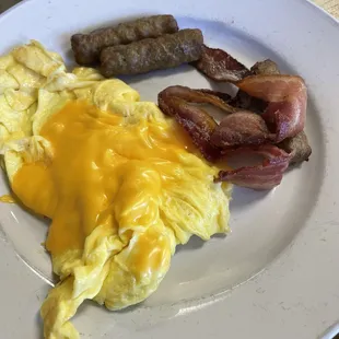 Scrambled eggs with cheese, bacon and sausage
