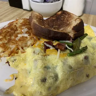 Mother&apos;s Day special asparagus, kielbasa, havarti cheese omelette with hash browns and whole wheat toast