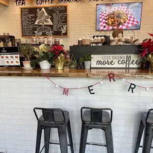 a counter with three metal stools