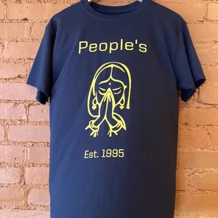 a t - shirt hanging on a brick wall