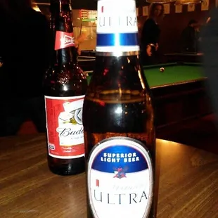 two bottles of beer on a table