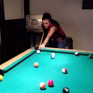 a woman playing pool