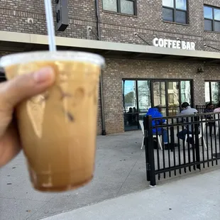 a person holding a cup of coffee