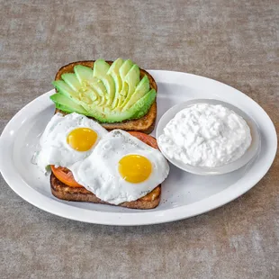 a plate of food with eggs, avocado and yogurt