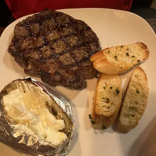 This is the 12oz ribeye with baked potato. The steak was WELL seasoned but not overly seasoned and cooked to perfection.