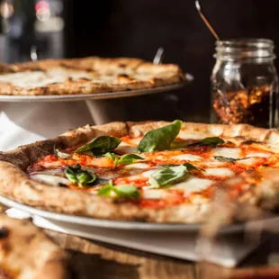 three pizzas on a table