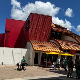 Outside seating with yellow umbrellas. Pepe's is across from the M&amp;M store.