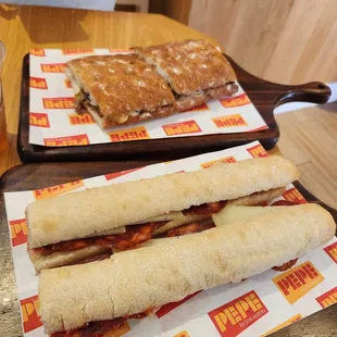 two sandwiches on trays