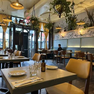 a dining area with tables and chairs