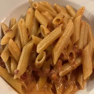 a plate of pasta with meat and sauce