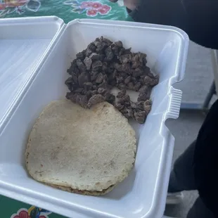 a mexican meal in a plastic container