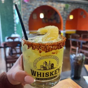 a hand holding a margarita