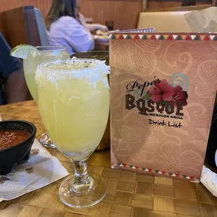Hey Caribbean, margarita with coconut around the rim and a house. Margarita in the background.
