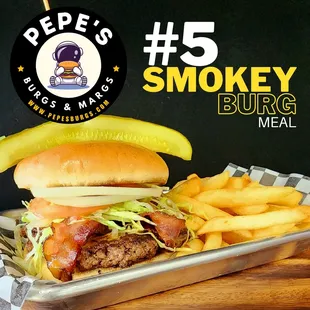 a smokey burger with fries and a pickle