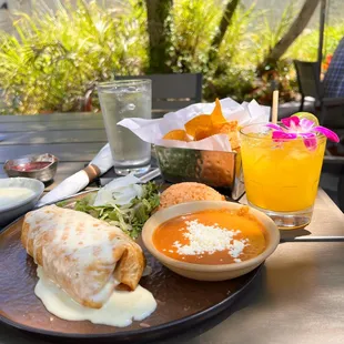 Shredded Chicken chimichanga with refried beans and rice. Mango margarita on the rocks.