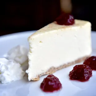 Cheesecake with fresh berries and whipped cream.