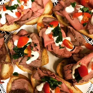 Choice Prime Beef Bruschetta drizzled with a Horseradish Sour Cream sauce.