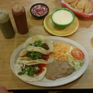 Tacos pastor and chips with queso.