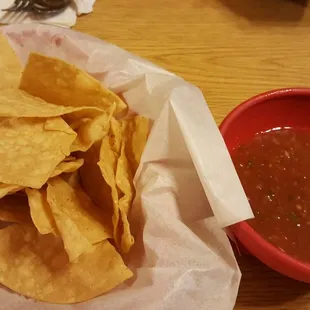 a bowl of chips and a bowl of salsa