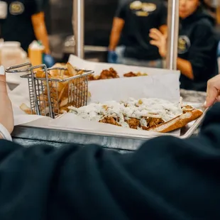 a person serving food at a restaurant