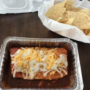 Burrito smothered in enchilada sauce and baked with cheese