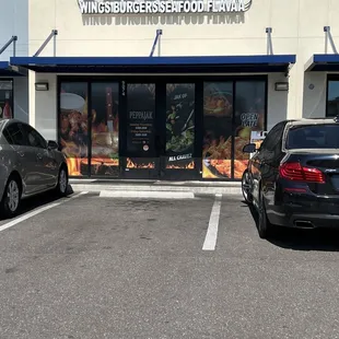 two cars parked in front of a restaurant
