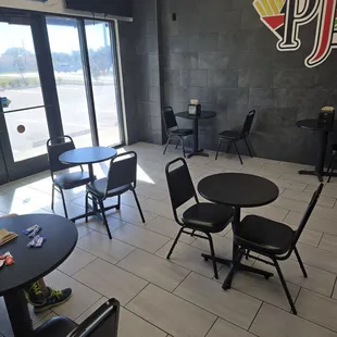 Interior with six tables of two chairs each.  Everyone doing to-go.  Nothing on TV.  Zero ambiance.