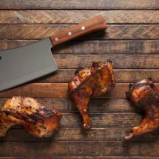 three pieces of meat on a cutting board