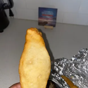 a hand holding a piece of food