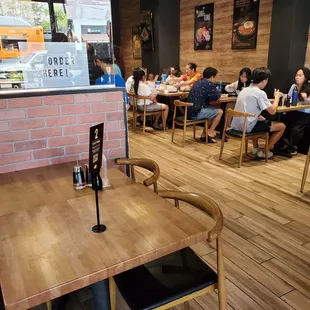 people sitting at tables in a restaurant