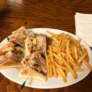 a plate of sandwiches and french fries