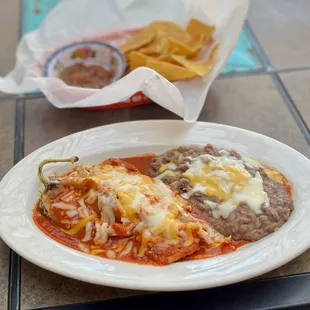 Relleno smothered in red, side of refried beans.  It's chile season. Gotta eat chile.