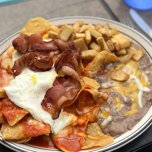 Chilaquiles rojo. Topped w/ egg and bacon. Delicious, but chips got soggy fast :(