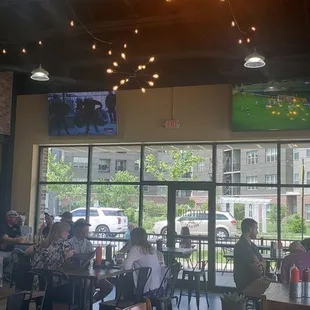 people sitting at tables in a restaurant