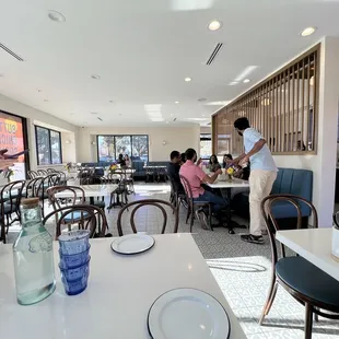 Dining room - utensils and napkins along with a flower arrangement.