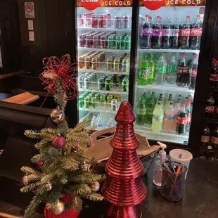 a christmas tree in front of a vending machine