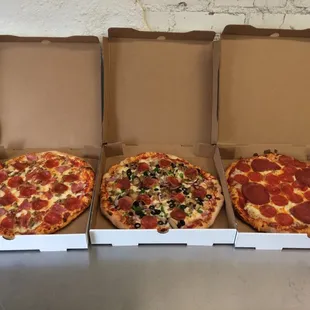 three pizzas in boxes