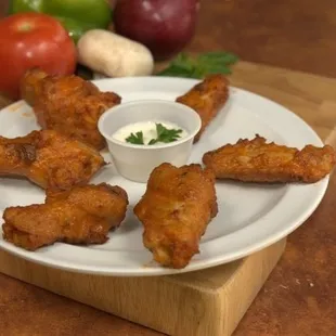 a plate of fried chicken wings