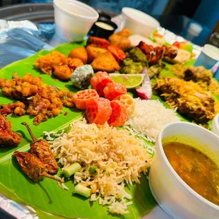 a plate of food on a banana leaf