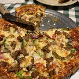 a pizza with a slice taken out of it