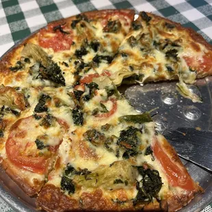 a pizza with a slice taken out of it